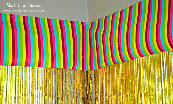 Kids St Patricks Day Party Ideas use rainbow wrapping as a window valance