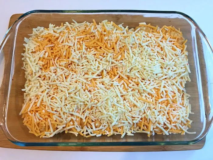 Spread shredded cheese over tater tots for Christmas morning casserole