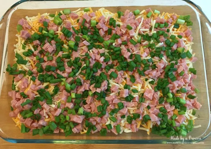 Sprinkle ham and green onions over shredded cheese and tater tots