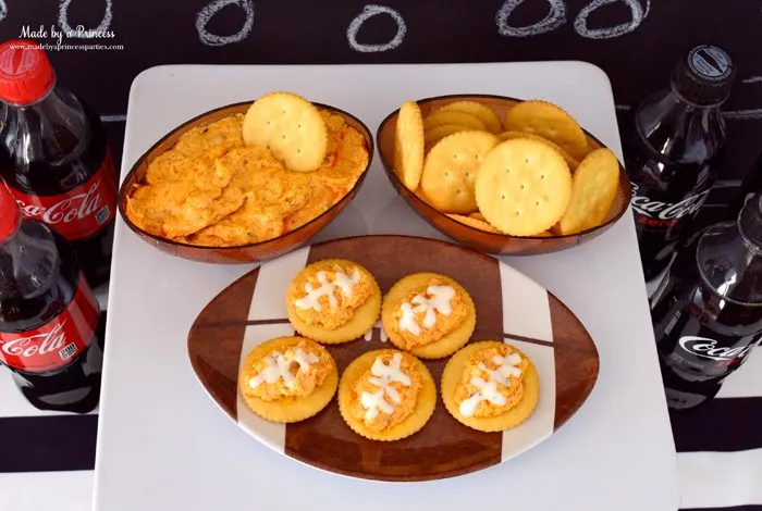 crock pot buffalo chicken dip on ritz crackers footballs