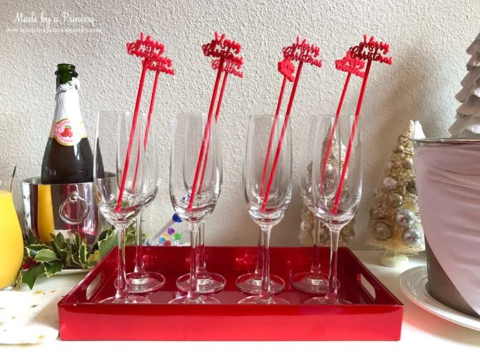 budget-friendly-holiday-mimosa-bar-party-merry-christmas-drink-stirrers-in-glasses-on-tray