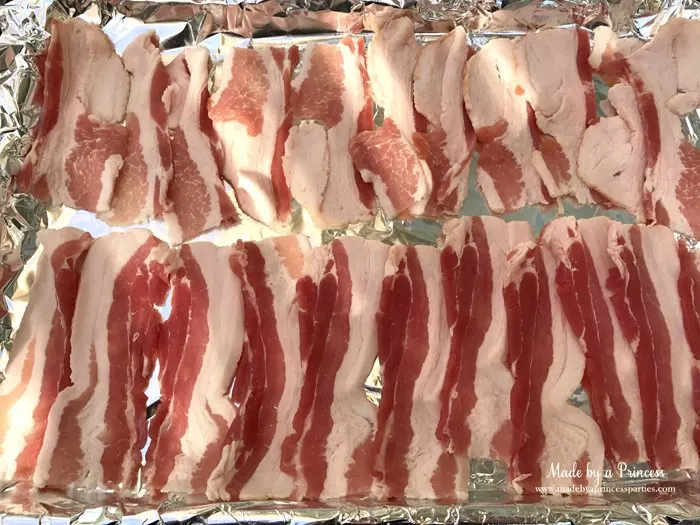 Man Candy Sweet Spicy Candied Bacon Recipe place bacon in a foil lined cookie sheet