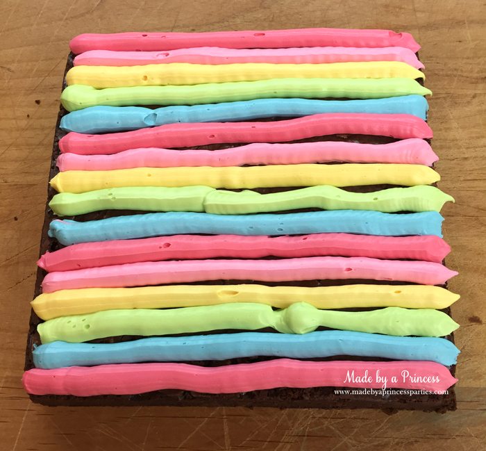Unicorn Party Rainbow Brownies Recipe pipe frosting in alternating colors 