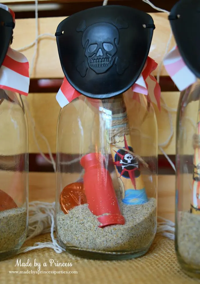 Pirate Bottle Invitations Party Idea fill bottom of glass milk bottle with sand add scope rolled invite coins and finish with eye patch