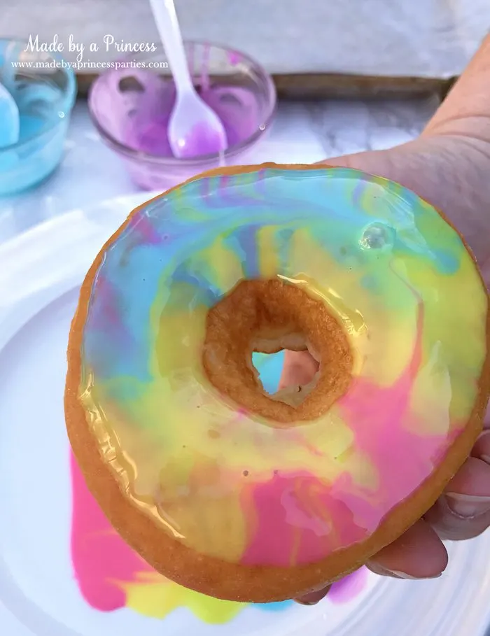 Rainbow Donuts Party Food Tutorial place donut face down in sugar glaze