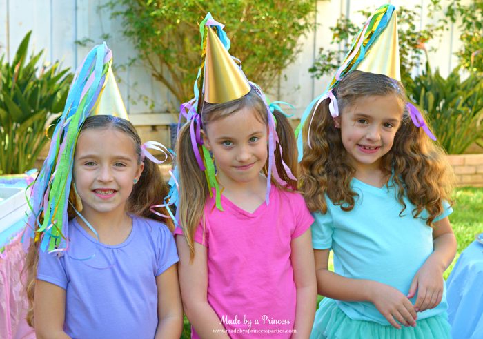 unicorn princess party hat idea tutorial custom hat made from crepe paper and curling ribbon little guests looking so cute