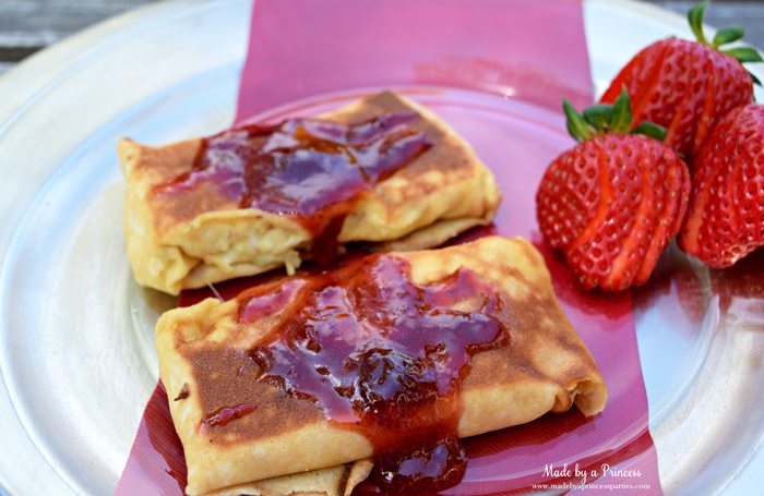 Savory Strawberry Preserves Toasted Coconut Almond Chicken Blintz Recipe top with warm strawberry jam