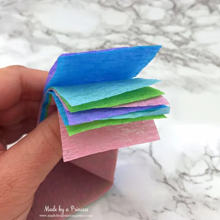 unicorn tail party idea tutorial cut 2 strips of each color of crepe paper
