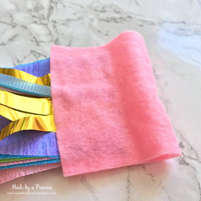 unicorn tail party idea tutorial fold piece of felt over streamers glue and trim