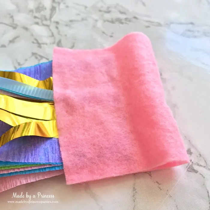 unicorn tail party idea tutorial fold piece of felt over streamers glue and trim