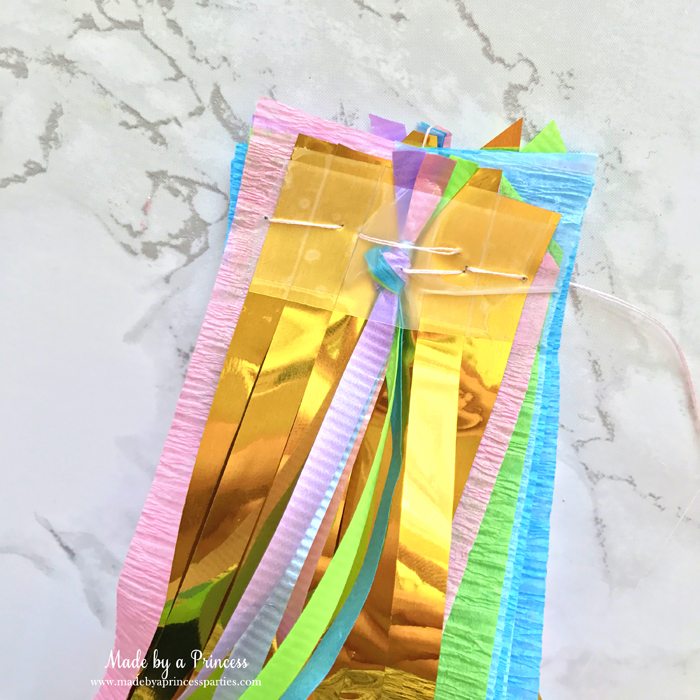 unicorn tail party idea tutorial two layers of gold fringe and two curling ribbon bundles sewn together