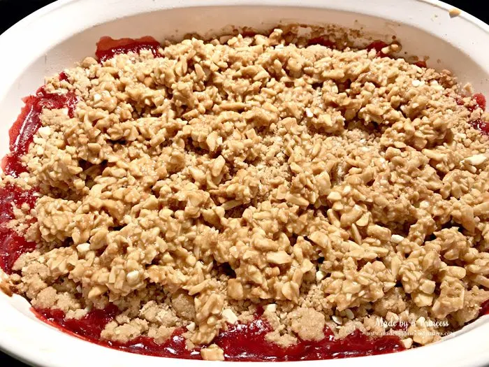 strawberry almond cobbler spread mixture on top of strawberries | Made by a Princess