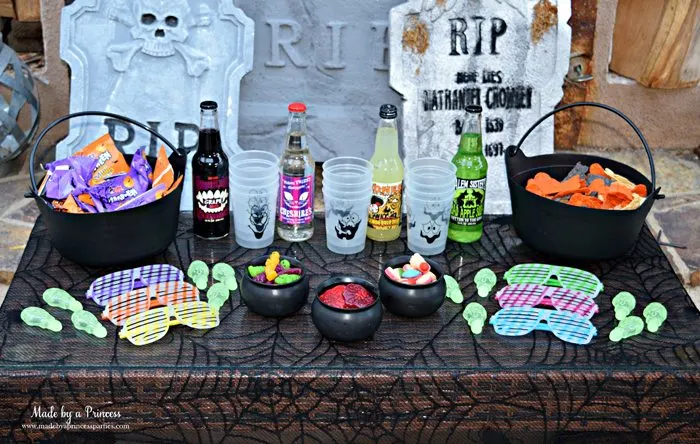 Teen Halloween Party Ideas simple table of snacks drinks and treats Made by a Princess #halloweenparty #teenhalloween