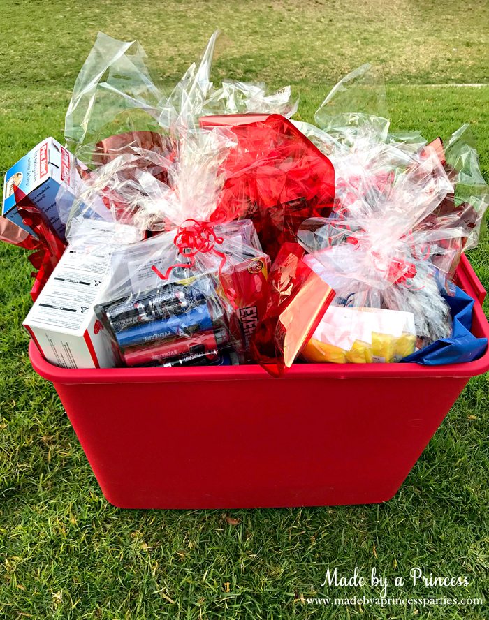 Unique School Silent Auction Idea Emergency Preparedness Kit items wrapped in cellophane and placed in bucket with ribbon