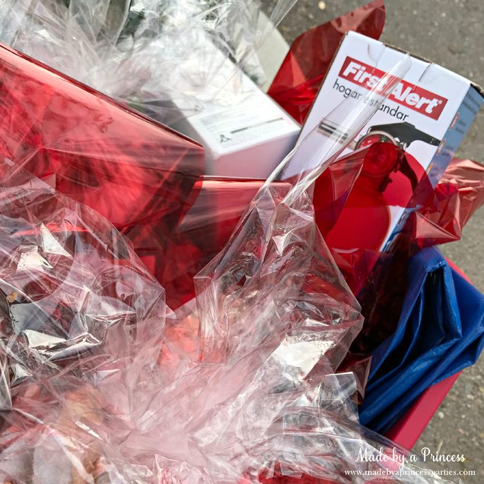 Unique School Silent Auction Idea Emergency Preparedness Kit items wrapped in cellophane and placed in bucket