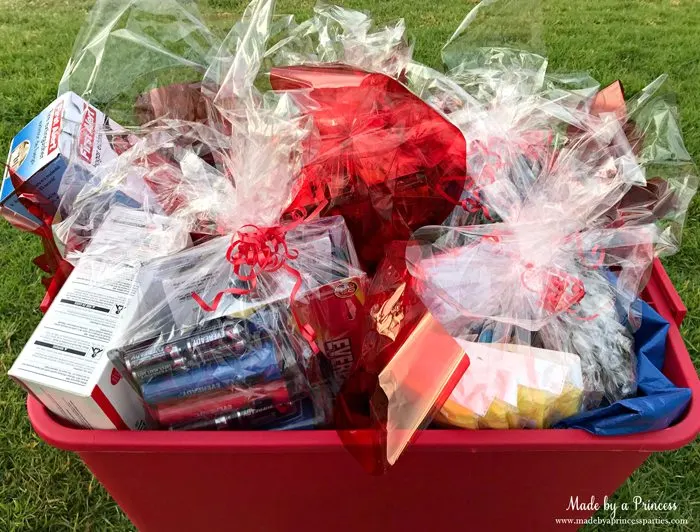 Unique School Silent Auction Idea Emergency Preparedness Kit items wrapped in cellophane in bucket ready to take home