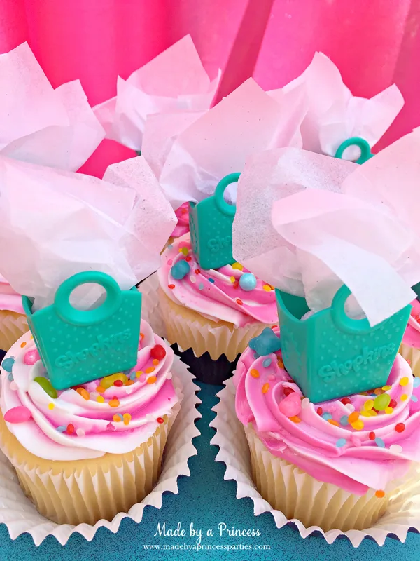 Shopkins Birthday Party Ideas use Shopkins shopping bags as cupcake toppers