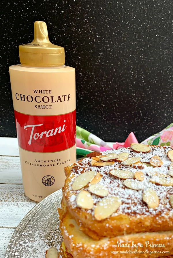 Garnish marzipan stuffed french toast with Torani White Chocolate Sauce