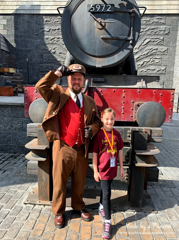 Greeted by the conductor in Hogsmeade in Wizarding World of Harry Potter