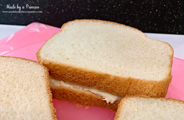 Place piece of bread on top of slice with filling to create a sandwich for this marzipan stuffed french toast recipe