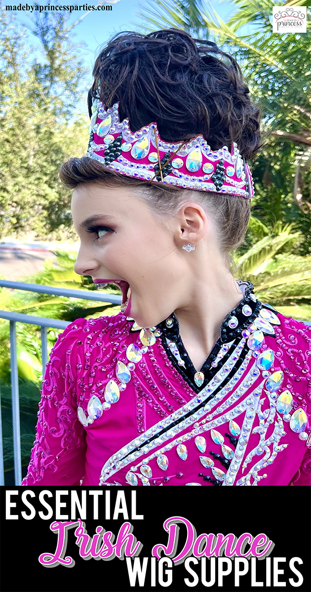 Side profile of an Irish dancer with a big smile in a high bun wig and bright pink sparkly competition dress
